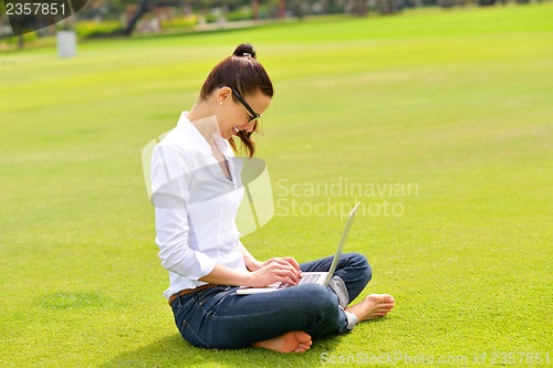 Image of woman with laptop in park