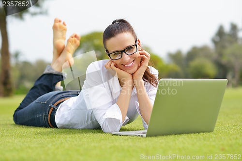 Image of woman with laptop in park