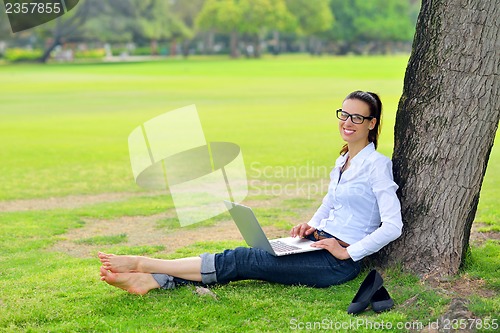 Image of woman with laptop in park