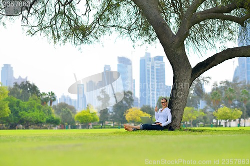 Image of woman with laptop in park