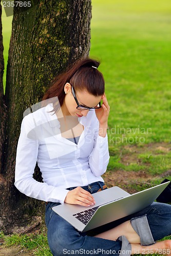 Image of woman with laptop in park