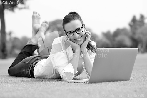 Image of woman with laptop in park