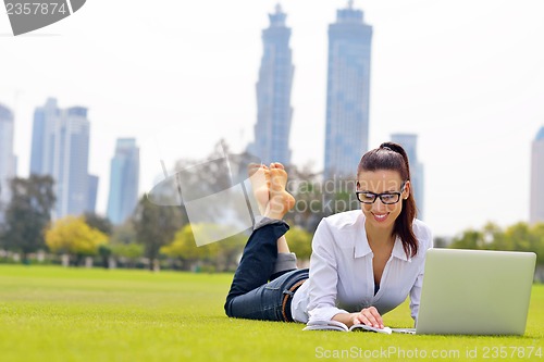 Image of woman with laptop in park