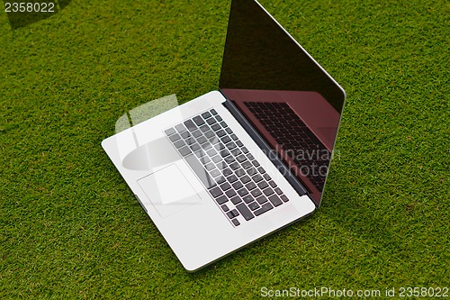 Image of laptop computer  on grass