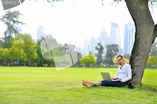 Image of woman with laptop in park