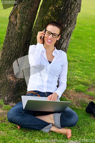 Image of woman with laptop in park