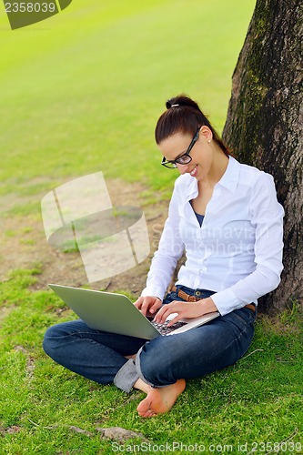 Image of woman with laptop in park