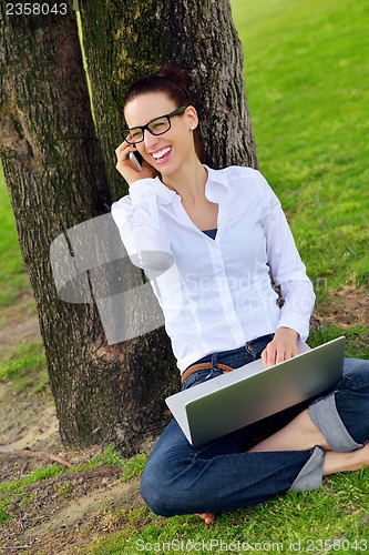 Image of woman with laptop in park