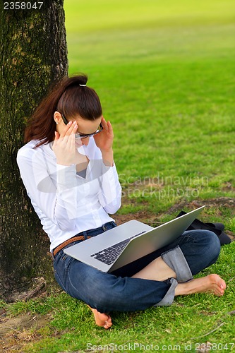 Image of woman with laptop in park