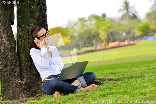 Image of woman with laptop in park