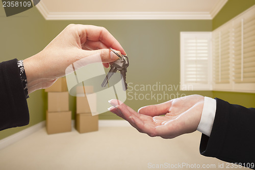 Image of Woman Handing Over the House Keys Inside Empty Green Room
