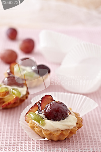 Image of butter cream and fruits cupcakes