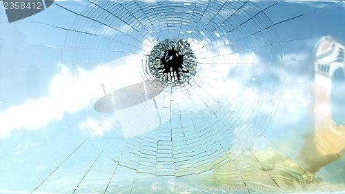 Image of Broken window glass and blue sky isolated 