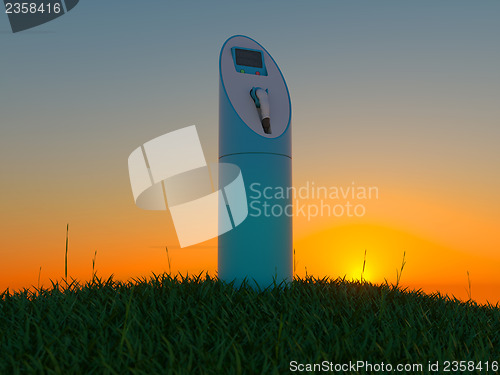 Image of Charging station in the green field at dawn