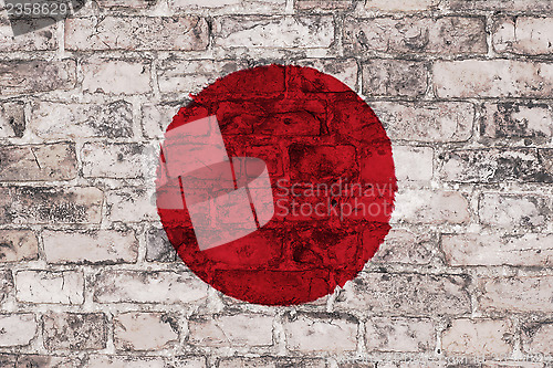 Image of Japanese flag on brick wall