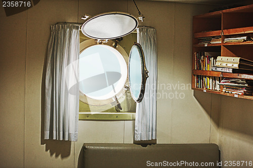 Image of Porthole in the cabin of an old yacht