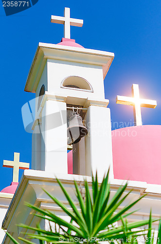 Image of Sunshine ray reflection in golden crosses on pink domes
