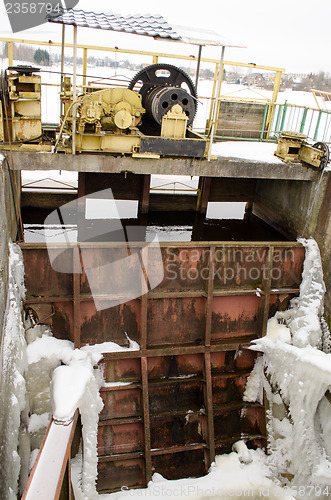 Image of frozen river dam mechanism gate winter 