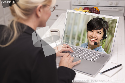 Image of Woman In Kitchen Using Laptop - Online with Nurse or Doctor