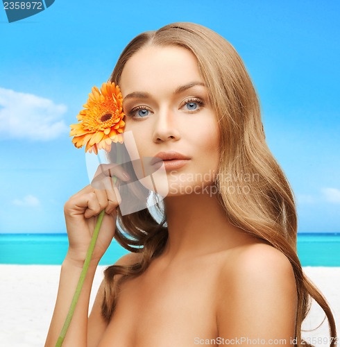 Image of lovely woman with gerbera flower