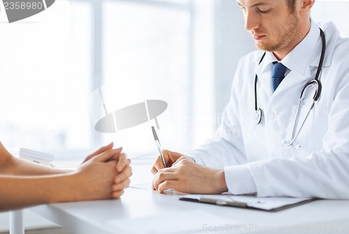 Image of patient and doctor taking notes