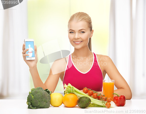 Image of woman with fruits, vegetables and tablet pc