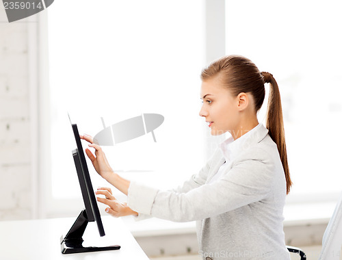 Image of smiling businesswoman with touchscreen in office