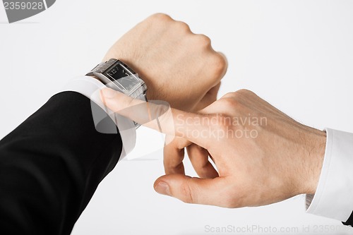 Image of man looking at wristwatch