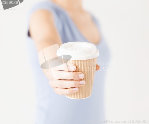 Image of woman hand holding take away coffee cup