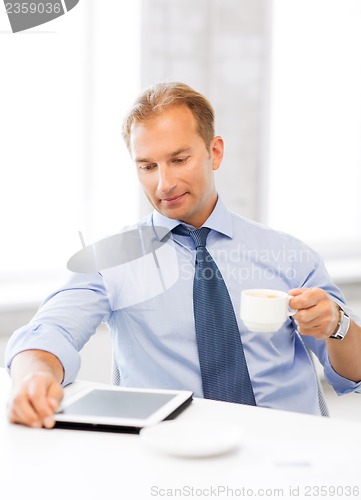 Image of businessman with tablet pc and coffee in office