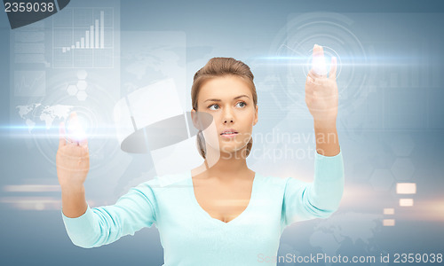 Image of businesswoman working with something imaginary