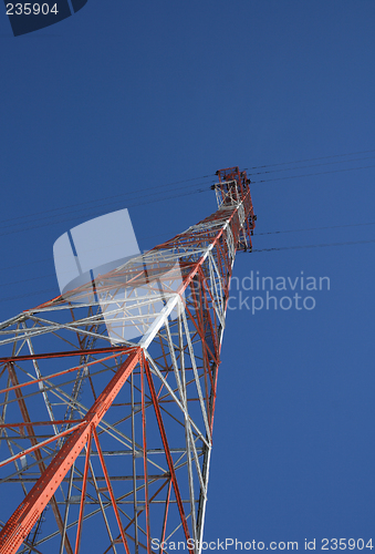 Image of Red and white power tower in the blue sky
