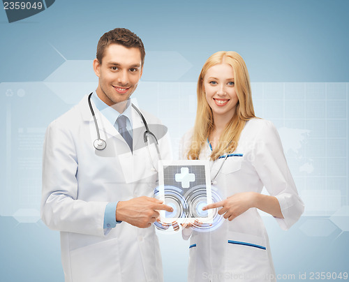 Image of young doctors pointing at tablet pc