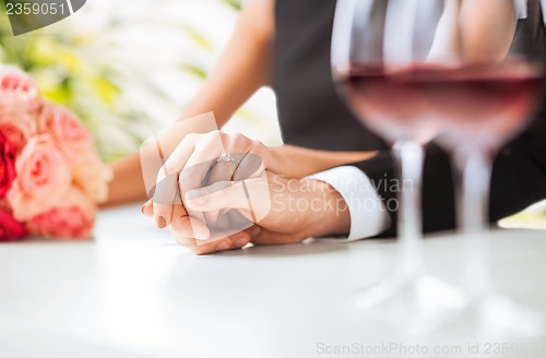 Image of engaged couple with wine glasses