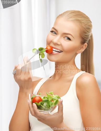 Image of healthy woman holding bowl with salad