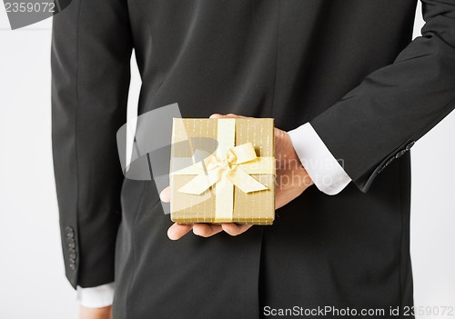 Image of man hands holding gift box