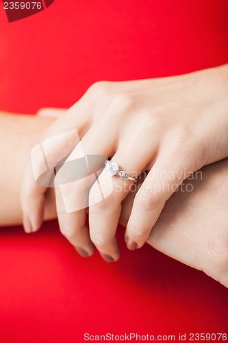 Image of woman showing wedding ring on her hand