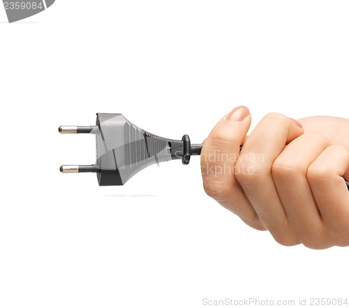 Image of hand holding black electrical plug with wire