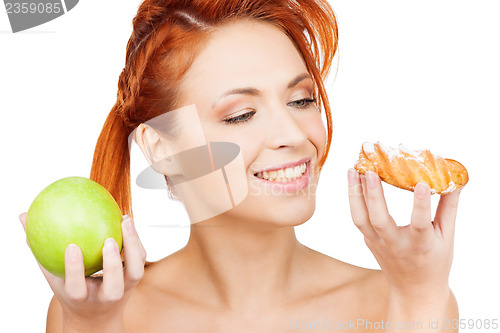 Image of pretty woman with apple and cake
