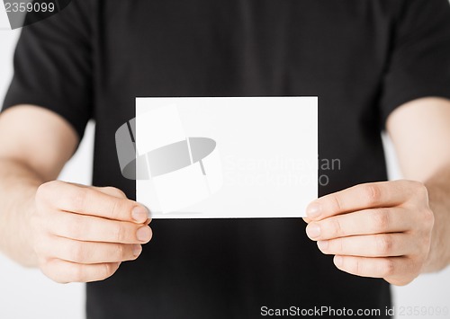 Image of man hand with blank paper