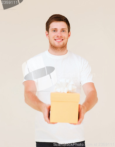 Image of man in white t-shirt with gift box
