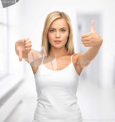 Image of woman with thumbs up and down