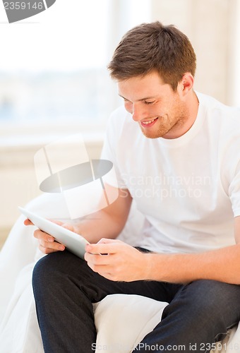 Image of man working with tablet pc at home