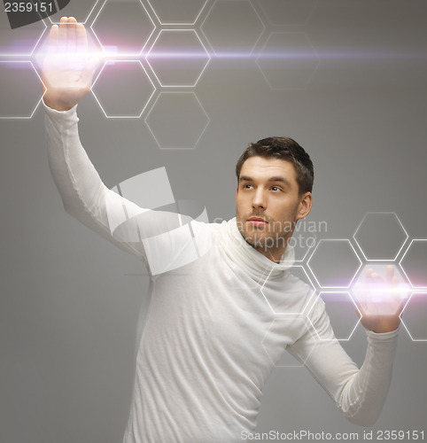 Image of futuristic man working with virtual screens