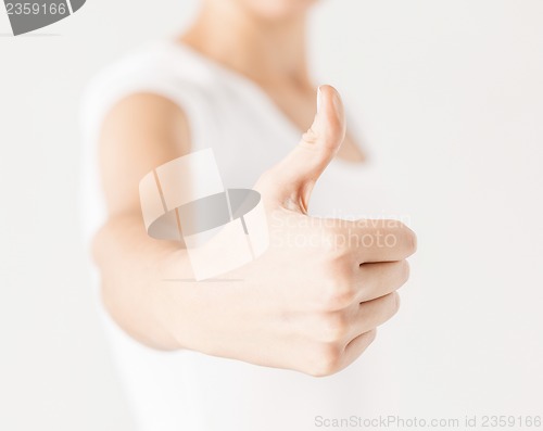 Image of woman showing thumbs up