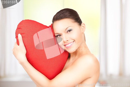 Image of woman with red heart-shaped pillow