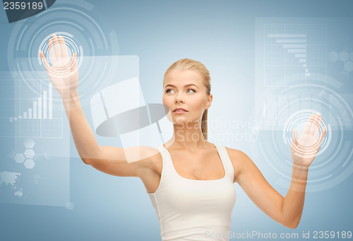 Image of businesswoman touching virtual screen