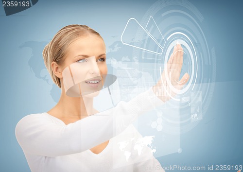 Image of businesswoman touching virtual screen