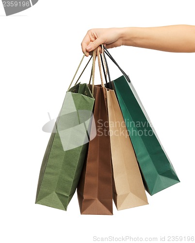 Image of woman hands holding shopping bags