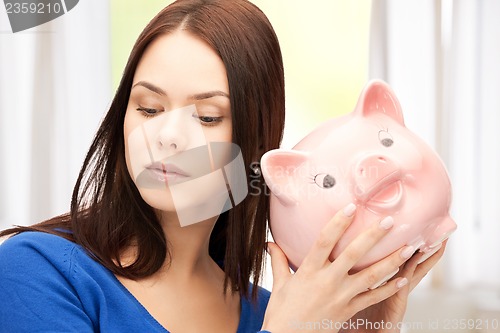 Image of lovely woman with piggy bank